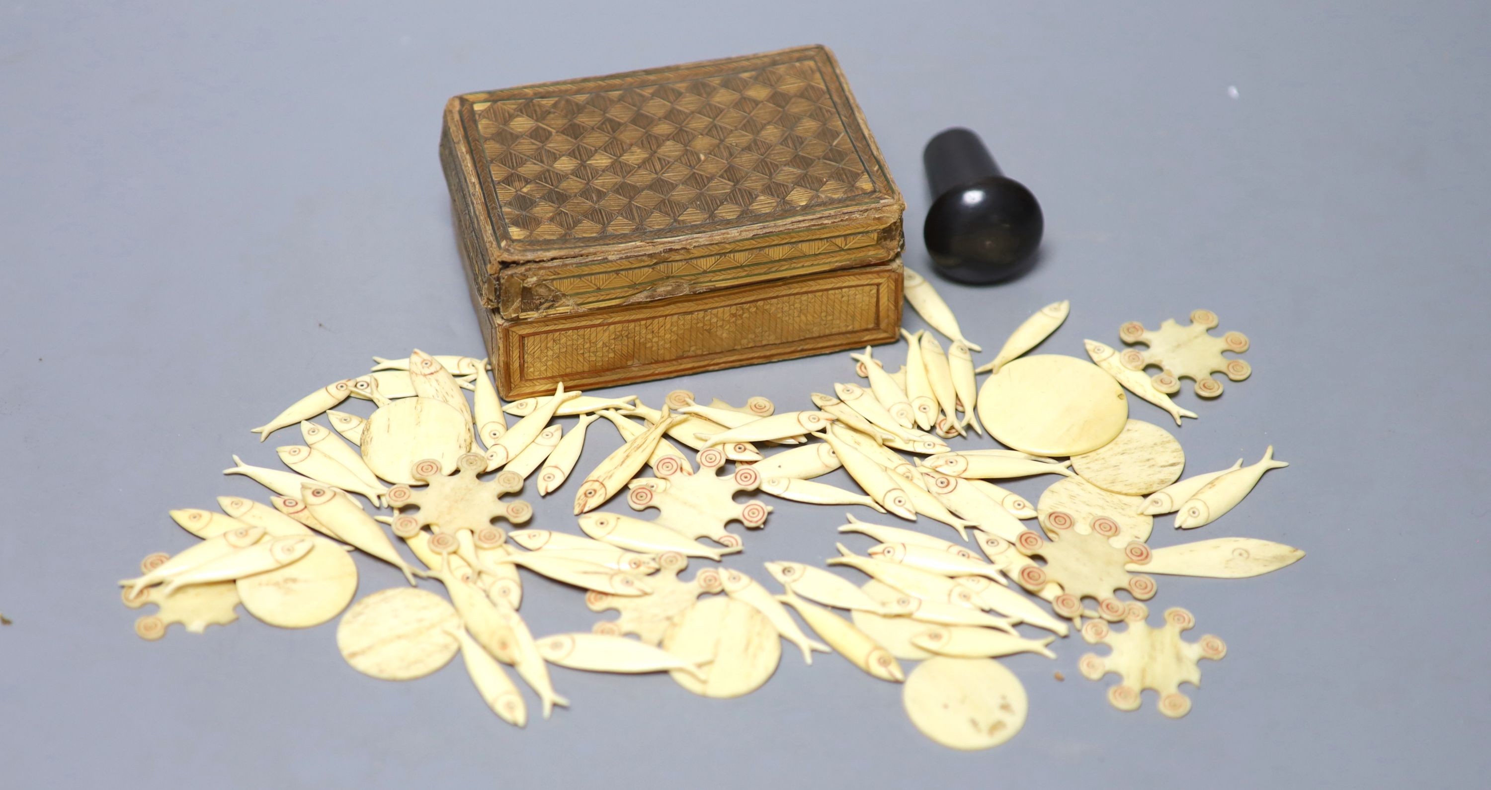 A small quantity of Victorian bone gaming counters, contained within straw work box and a dice shaker containing five dice